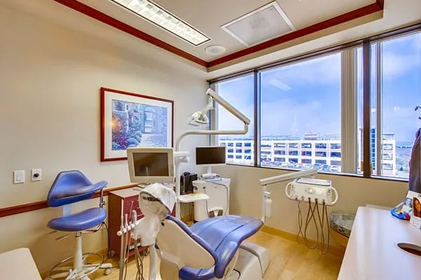A bright treatment room with large windows looking out over La Jolla